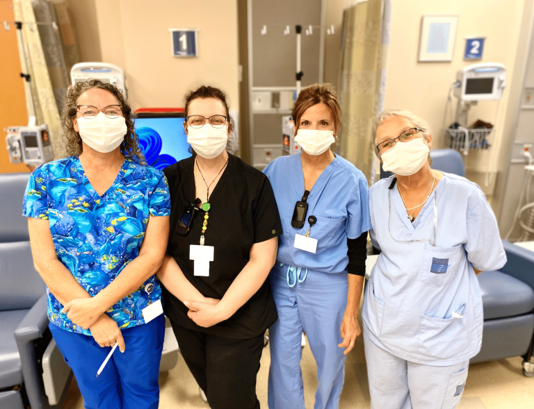 Four Ambulatory care nurses in scrubs and surgical masks